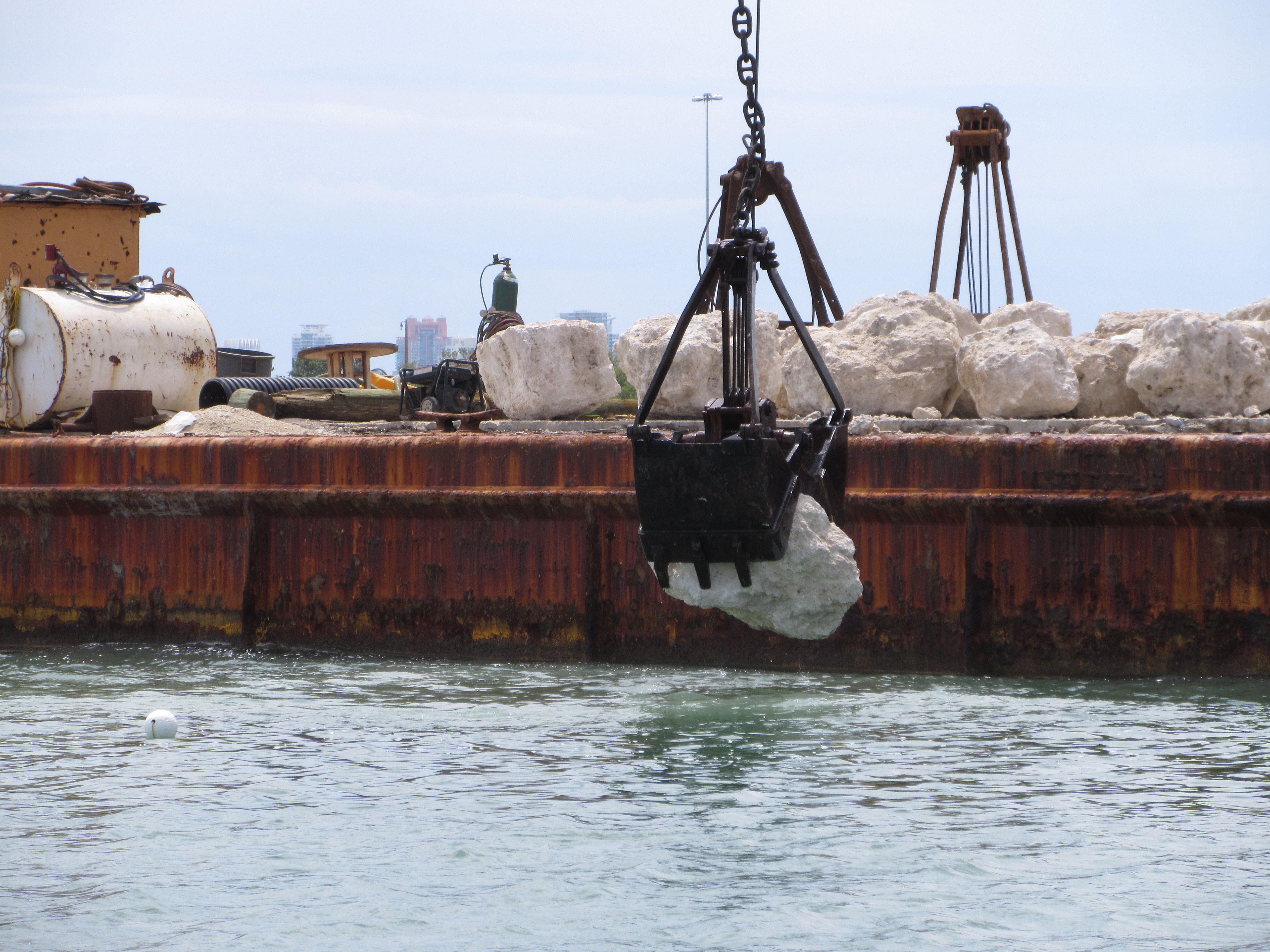 limerock boulder going in the water