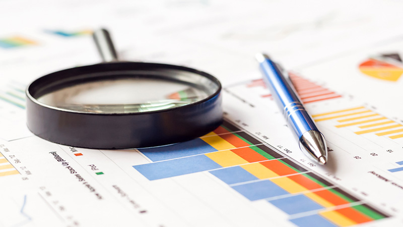 A magnifying lens placed over a report.