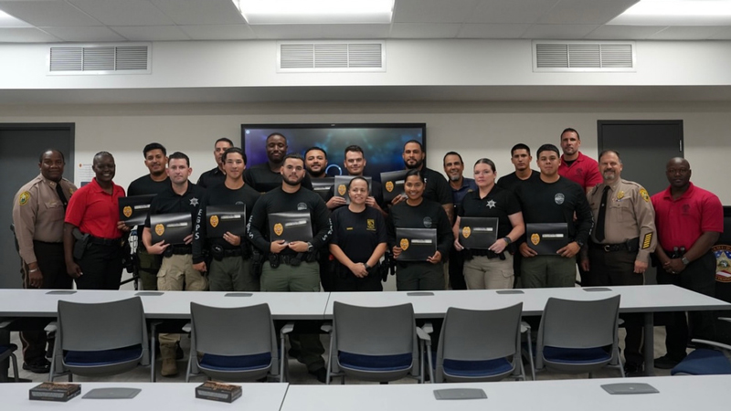 Graduates of MDSO Guardian Academy hold certificates at ceremony.