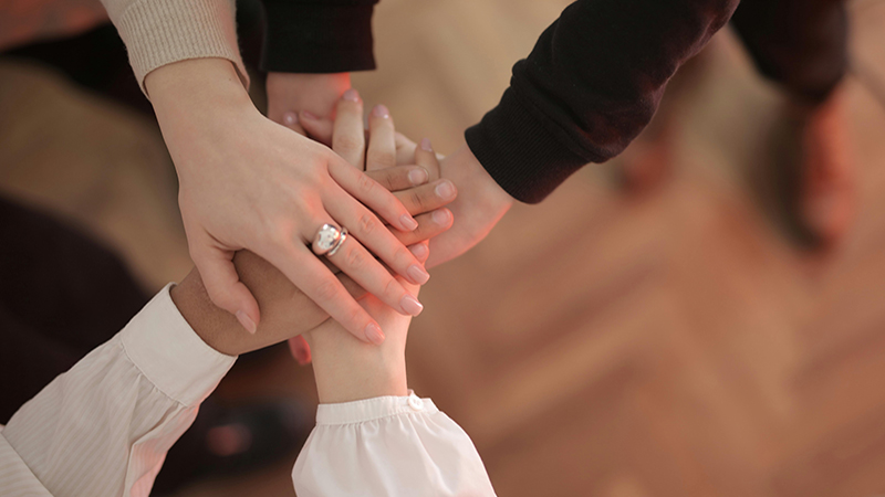 group of people standing in a huddle